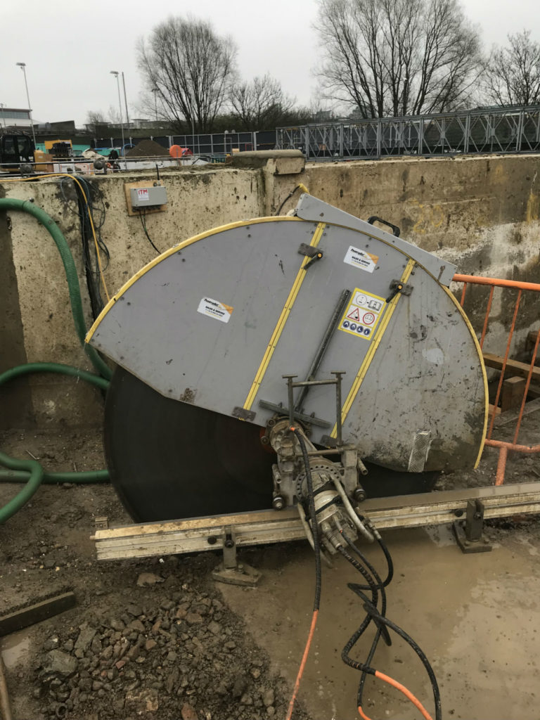 Track sawing to separate a slab from a tank