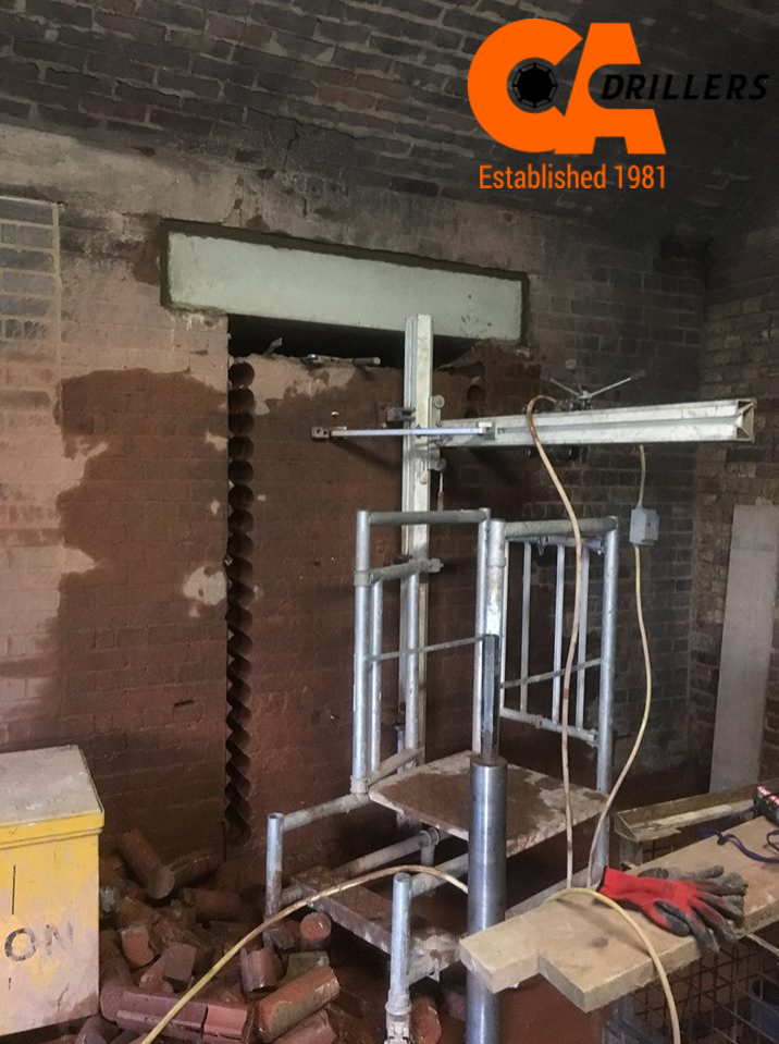 CA Drillers showing the drilling through a brick wall for a construction project